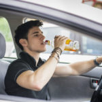 Guy drinking while driving